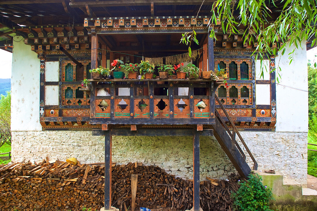 Typical Bhutanese house next to Thamshing Lhakhang in Bumthang Valley, Bhutan, Himalayas, Asia