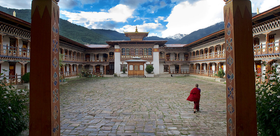 A nun in the courtyard of the Pema Choling Nunnery, Tang Tal, Bumthang, Bhutan, Himalayas, Asia