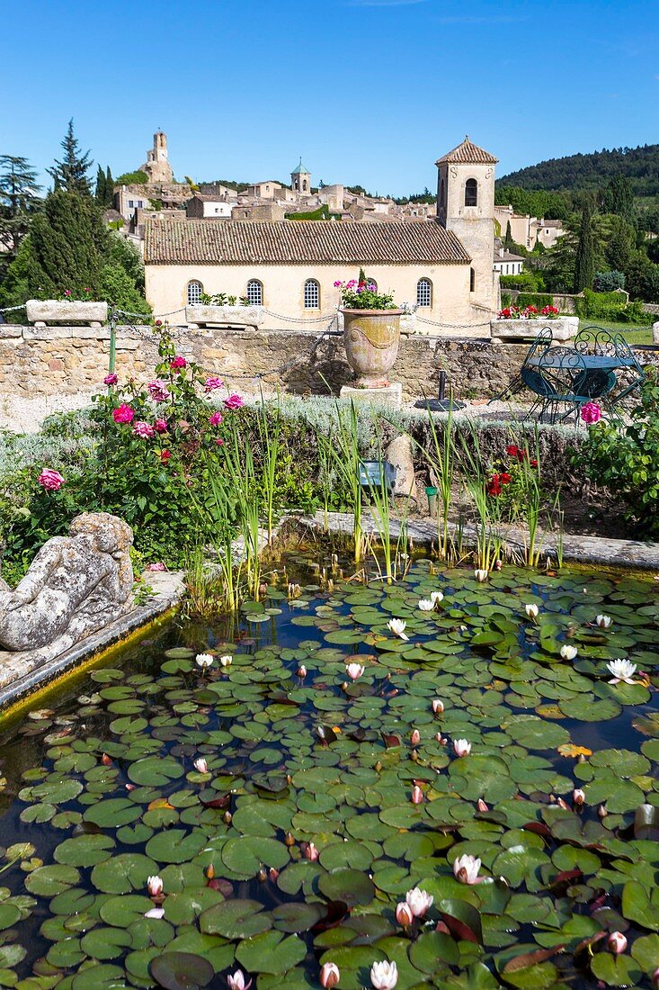 France, Vaucluse, Lourmarin, labeled Les Plus Beaux Villages de France (the Most Beautiful Villages of France), castle 15th and 16th centuries, classified as Historic Monument, pond at the foot of the castle