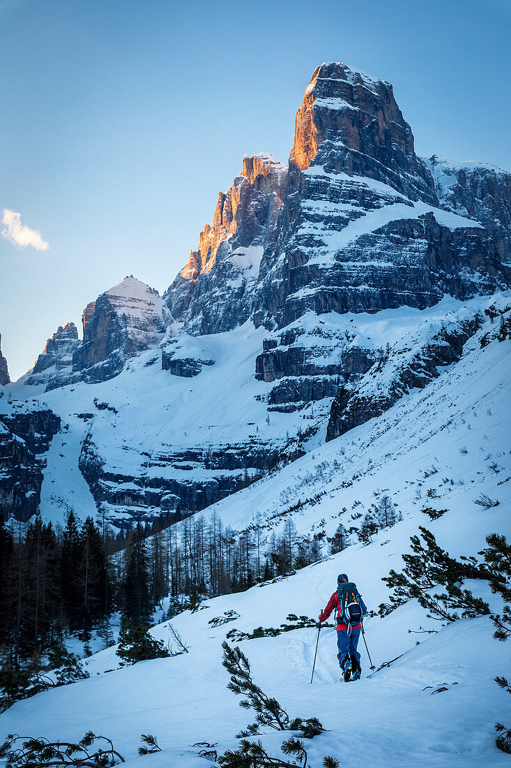 Ski tourers ascending to the Cima Tosa north channel, Brenta Group, Italy