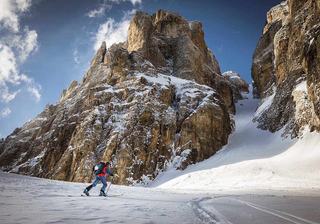 Ski tourer ascending to the Cima Tosa north channel, Brenta Group, Italy