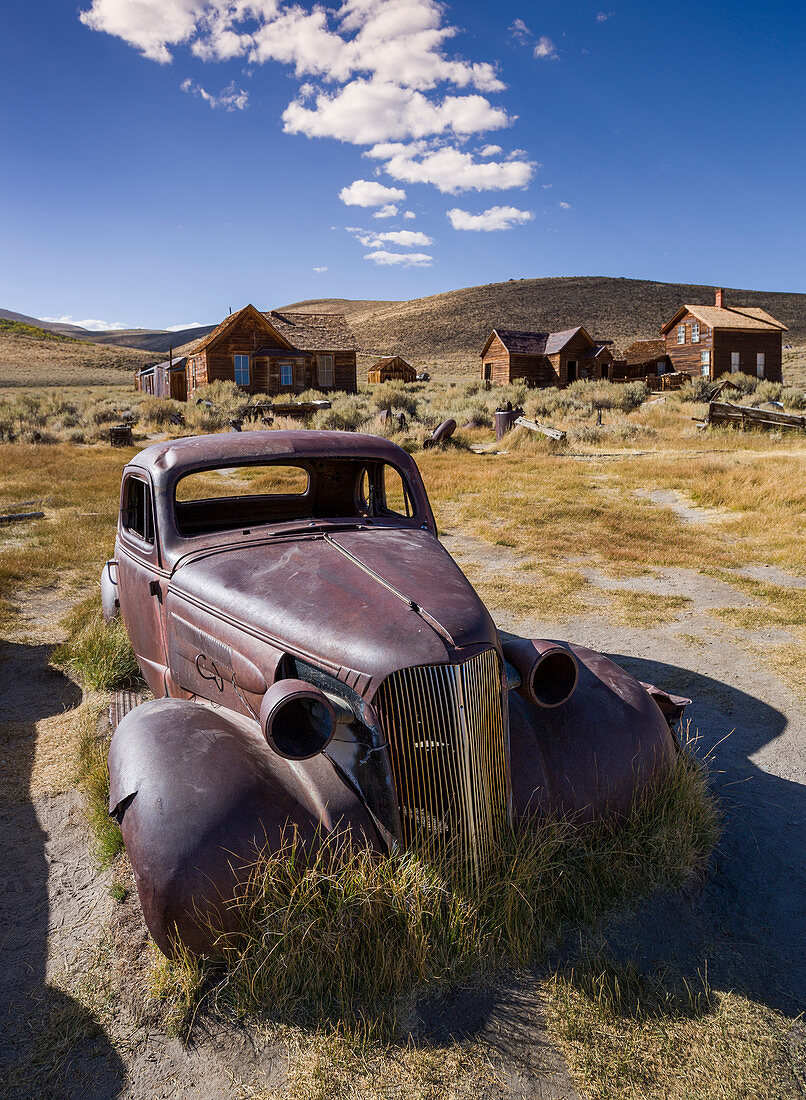 Rusted classic car in the ghost town of Bodie, an old gold mining town in California, USA