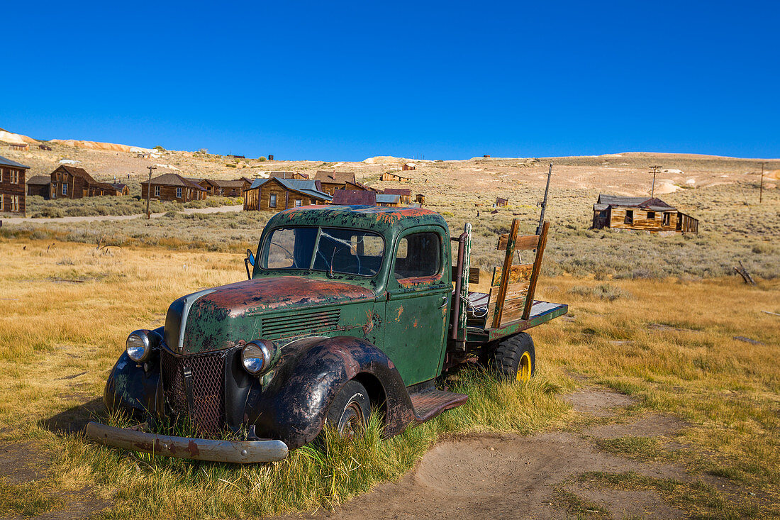 Rusted classic car in the ghost town of Bodie, an old gold mining town in California, USA