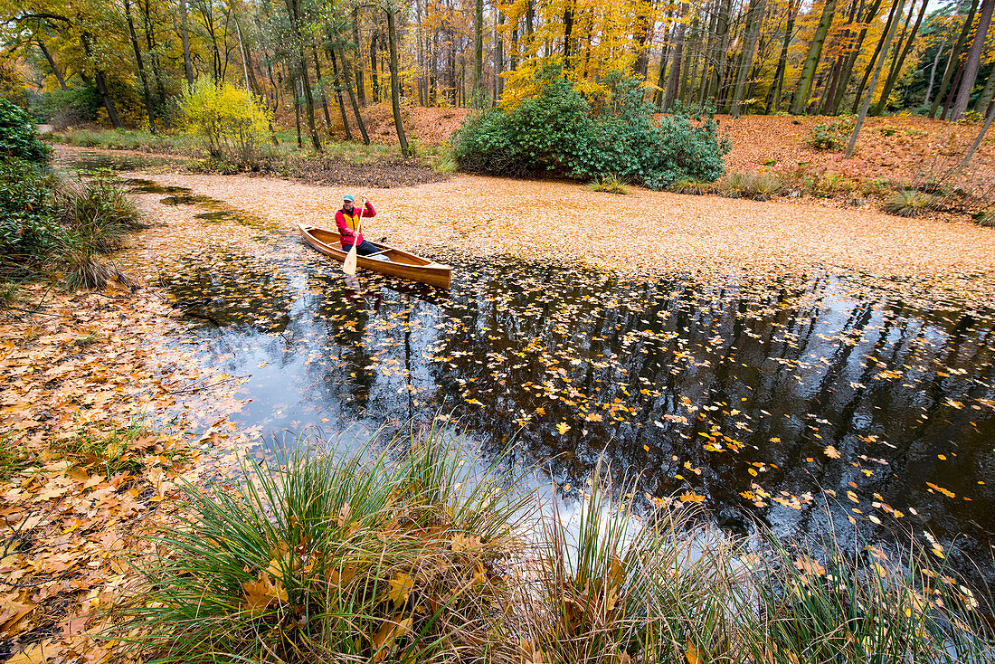 Canoeing in autumn on the Rakotzsee, Saxony, Germany