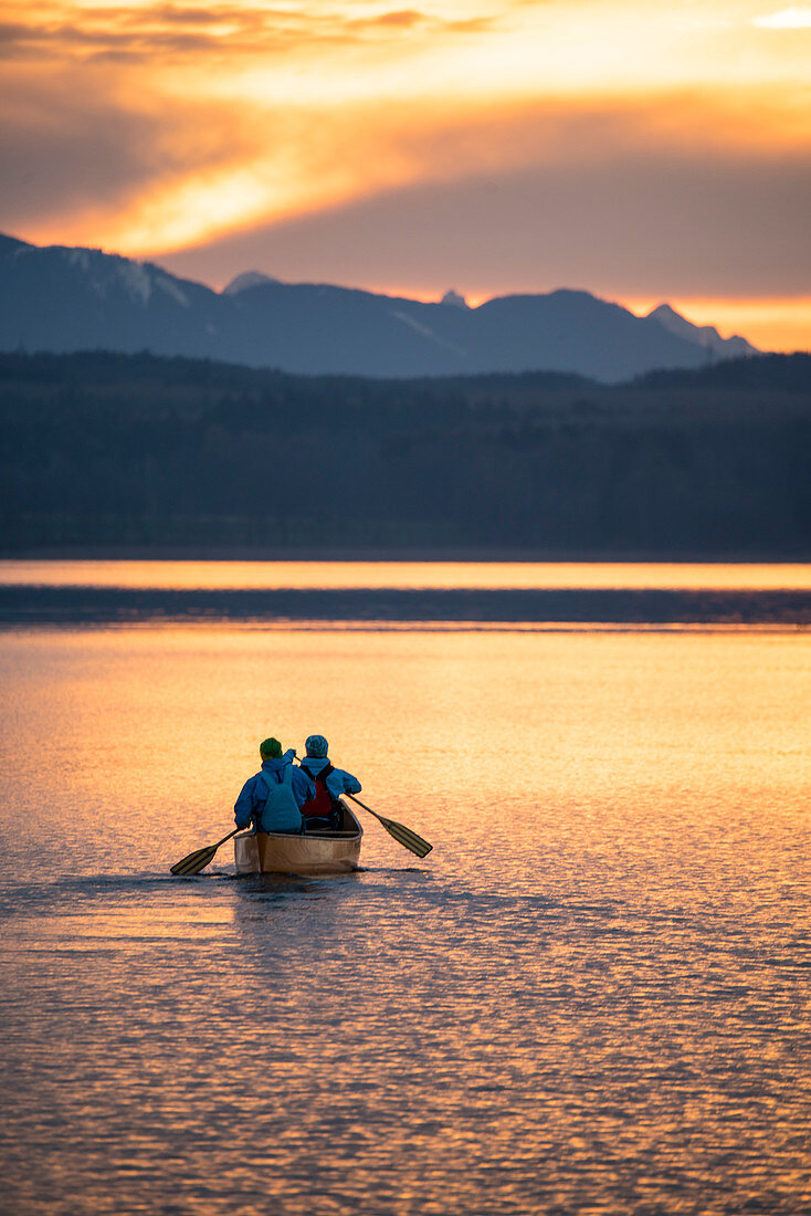 Evening canoe trip in Canadian on Lake Starnberg, Bavaria, Germany