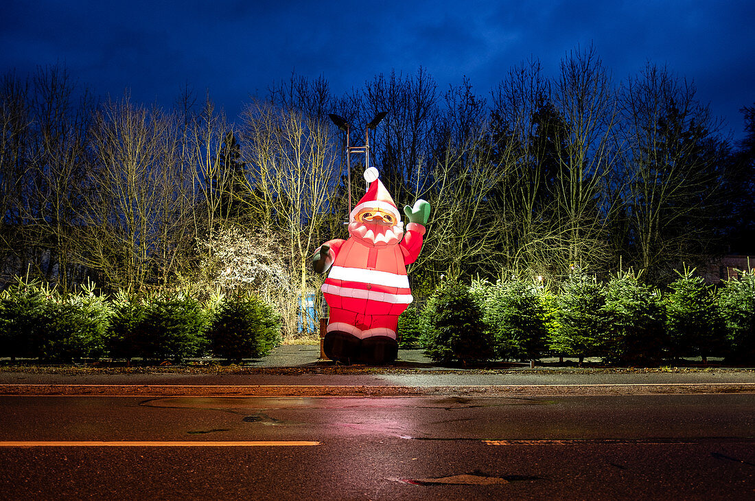Big Santa Claus as a decoration at a Christmas tree sale, Munich, Bavaria, Germany