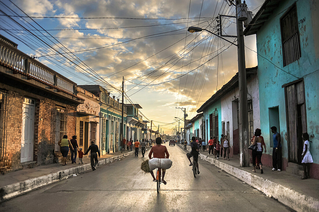 Boy bicycles straw through the streets of Trinidad. Cuba