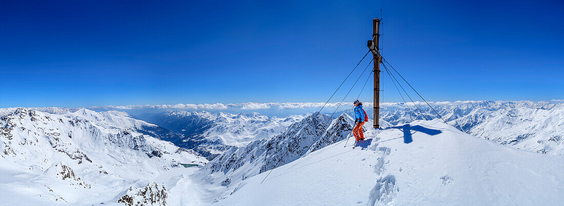 Panorama from the summit Hintere Eggenspitze with woman on ski tour, Hintere Eggenspitze, Ortlergruppe, South Tyrol, Italy