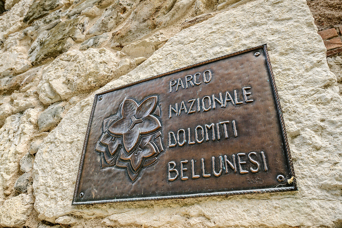 Sign of the Bellunesian Dolomites National Park with bluebells, Agordo, Bellunesian Dolomites National Park, Dolomites, Dolomites UNESCO World Heritage Site, Veneto, Italy