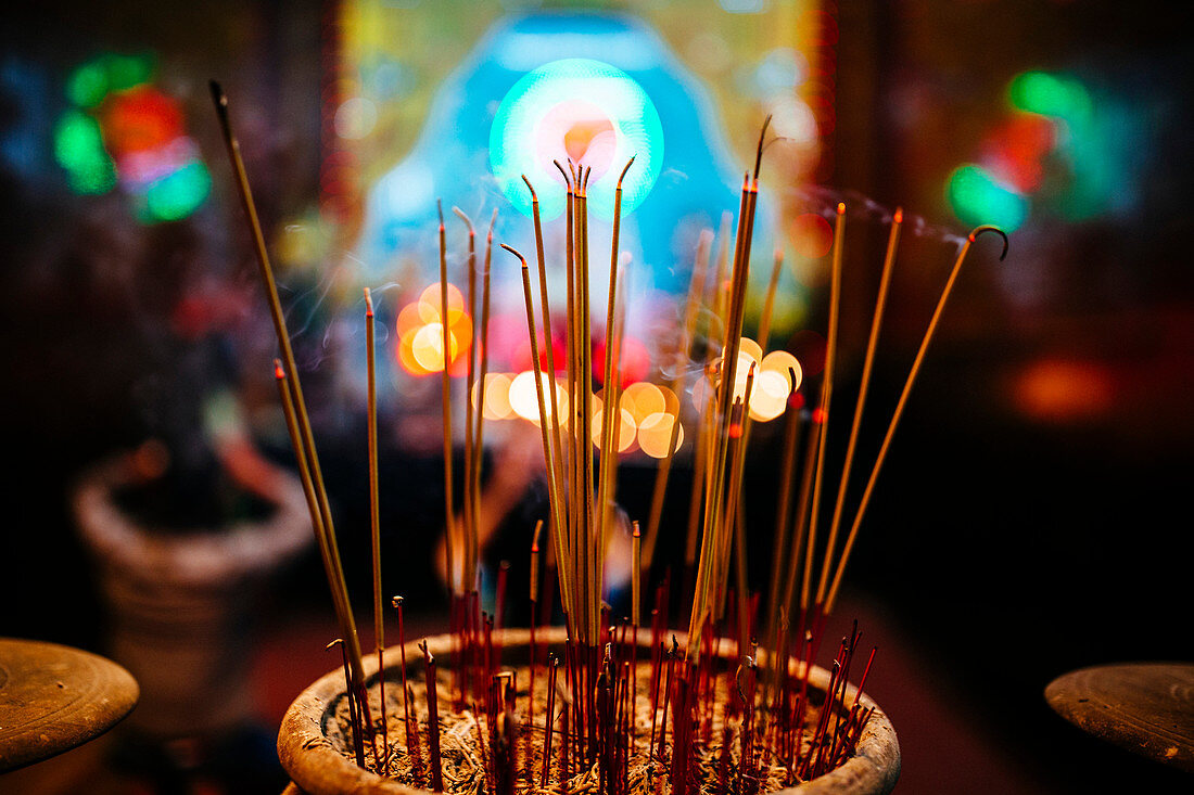 High angle close up of incense at a temple.