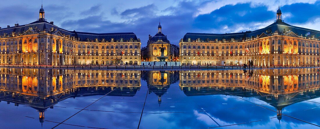 France, Gironde, Bordeaux, area listed as World Heritage by UNESCO, Bourse Place, La Lune harbour, night view of a historic building and its reflection on water esplanade