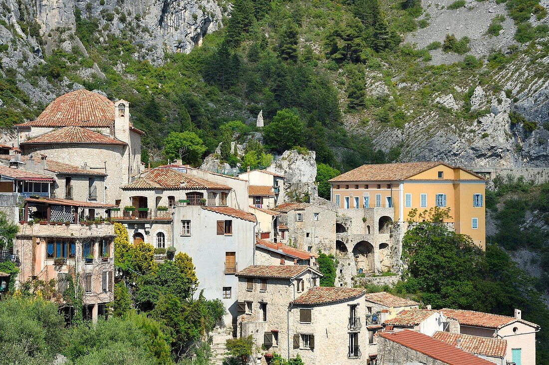 France, Alpes Maritimes, the hilltop village of Peille, the Chapel of St. Sebastian (town hall), the War Memorial and the Palais Lascaris, right on the edge of the cliff