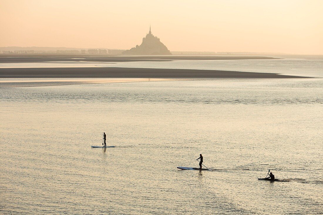 France, Manche, Mont Saint Michel bay, listed as World Heritage by UNESCO, a kayakists riding the Mascaret wave during fall high tides