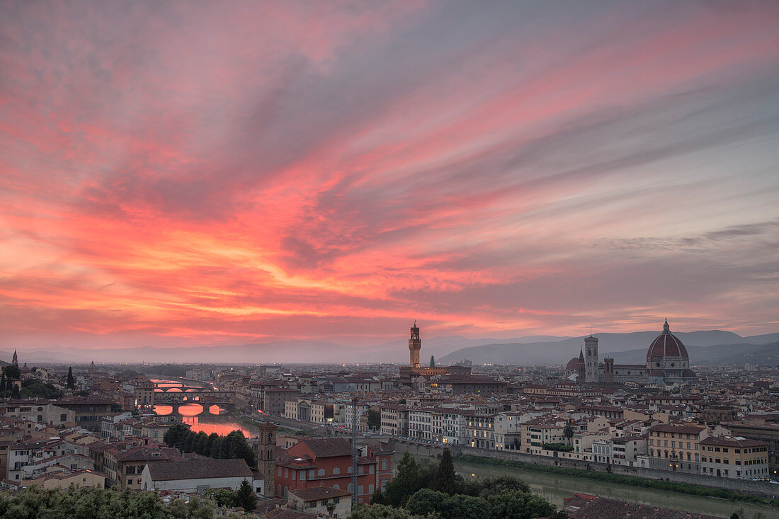 Pink clouds at sunset frame the city of Florence crossed by Arno River seen from Piazzale Michelangelo, Florence, Tuscany, Italy, Europe