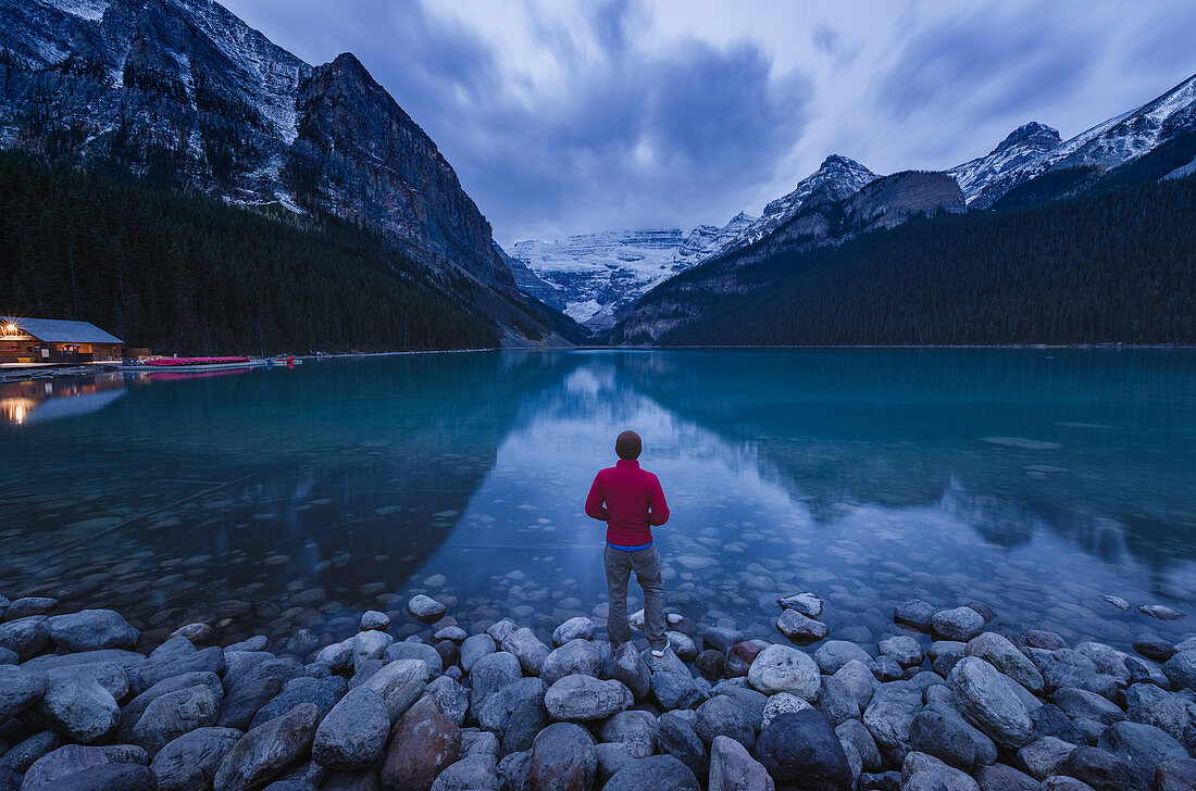 Lone traveler at Lake Louise in the morning, Banff National Park, UNESCO World Heritage Site, Canadian Rockies, Alberta, Canada, North America