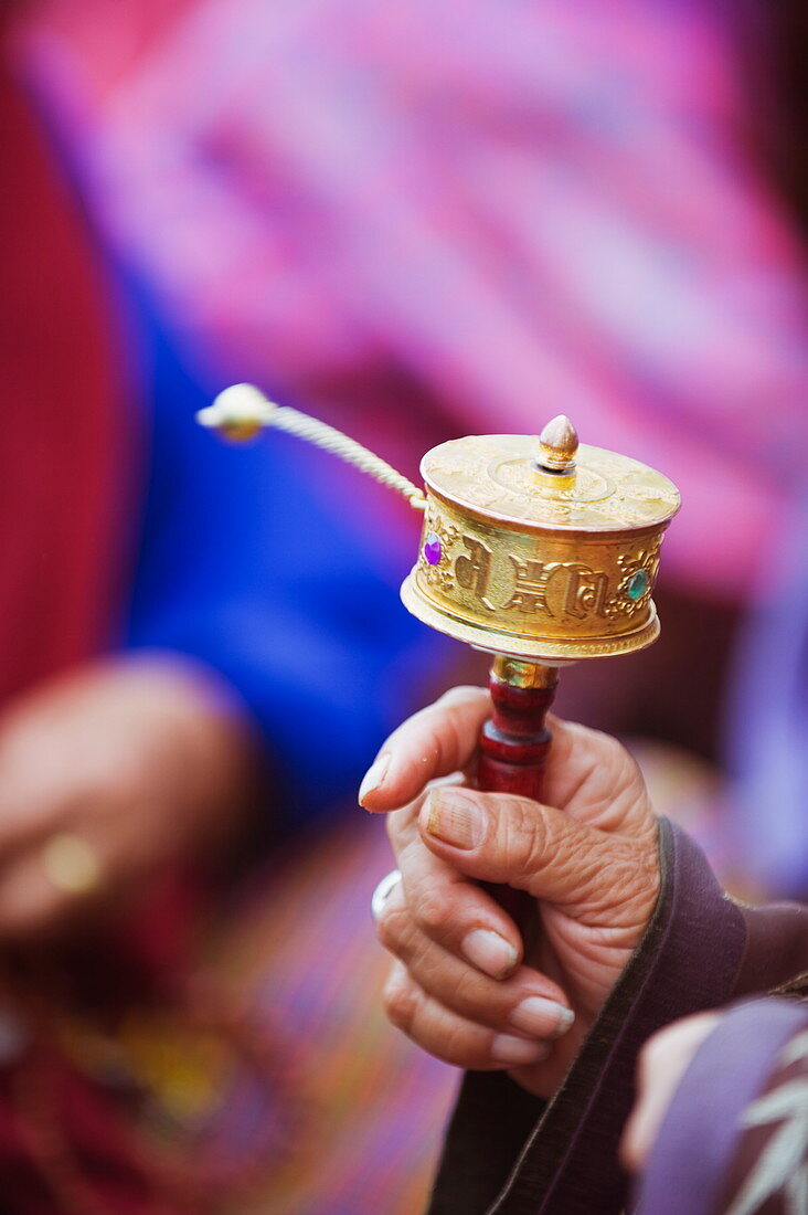 Prayer wheels being spun by a pilgrims at the National Memorial Chorten, Thimphu, Bhutan, Asia