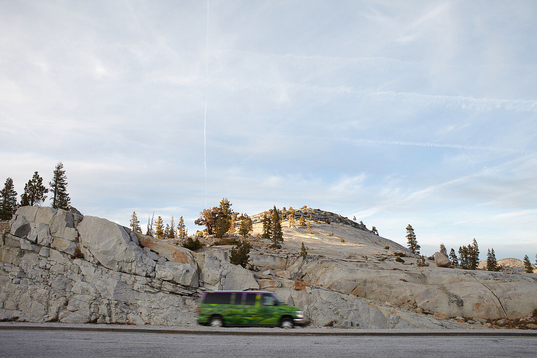 Tioga Road with a green car. Yosemite National Park, California, USA.