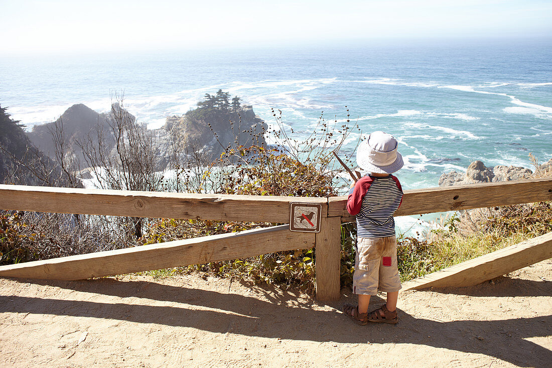Child looks out to sea from Big Sur. California, United States