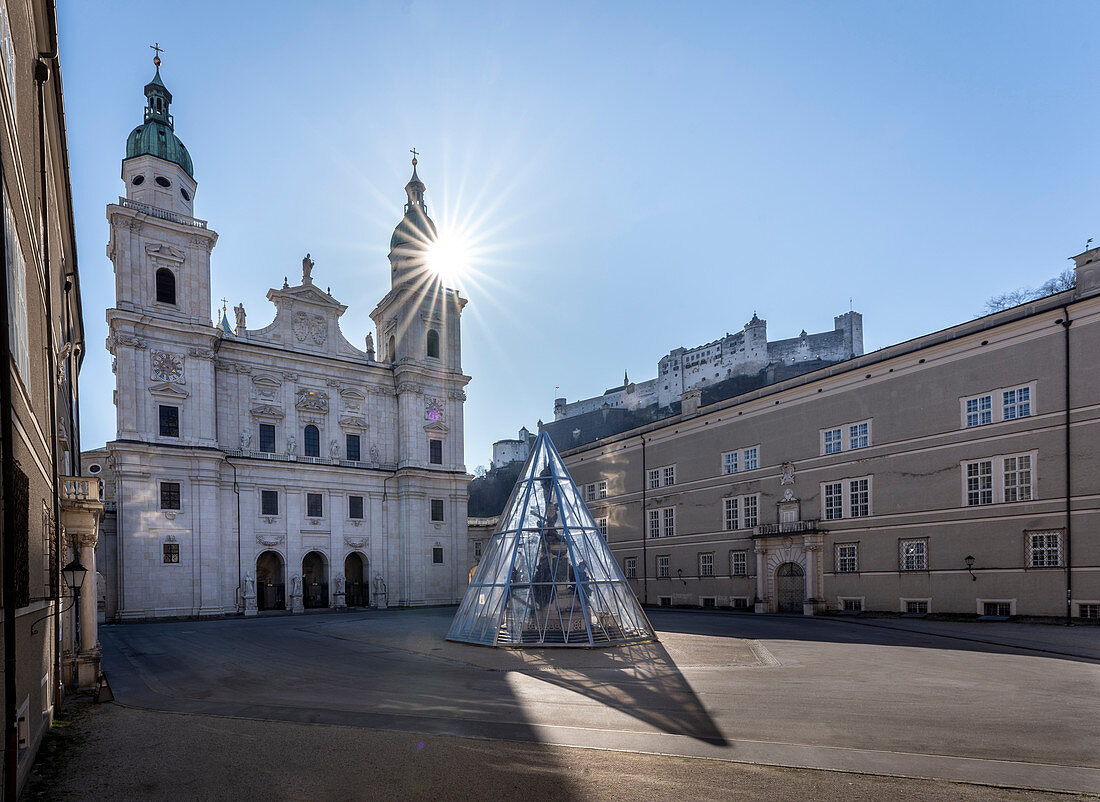 View from Salzburg Cathedral Square to Salzburg Cathedral with Hohensalzburg Fortress in the background in Salzburg, Austria