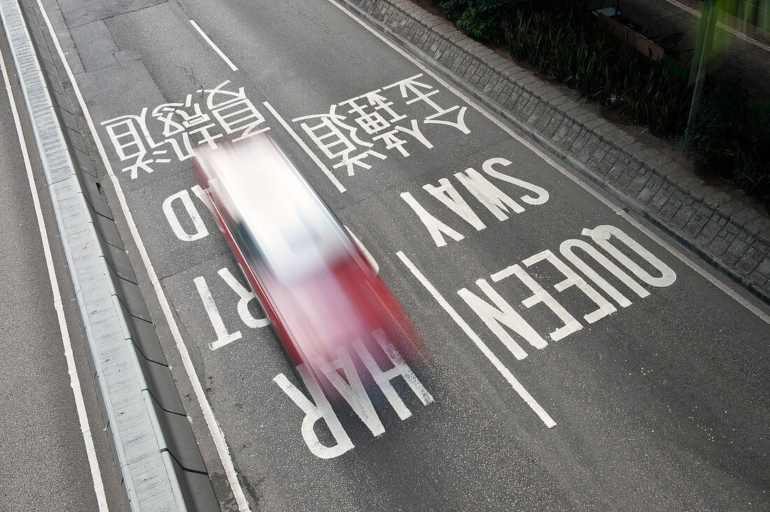 Hong Kong taxi drives over road signs, China