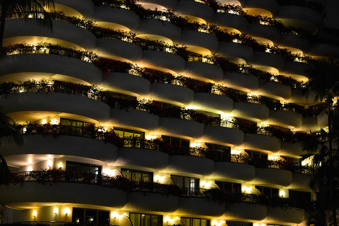 Balconies and terraces of the luxury hotel Shangri-La in Singapore illuminated at night