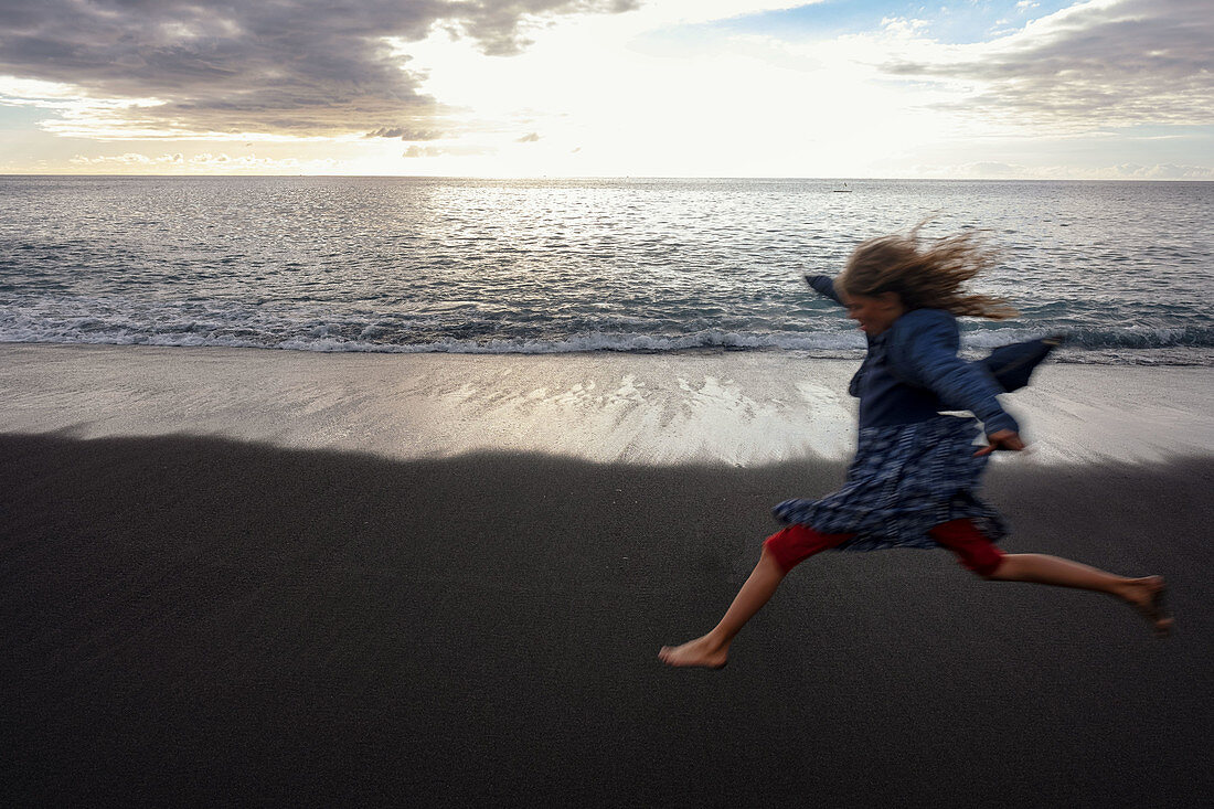 Jumping girl on El Remo beach, La Palma, Canary Islands, Spain, Europe