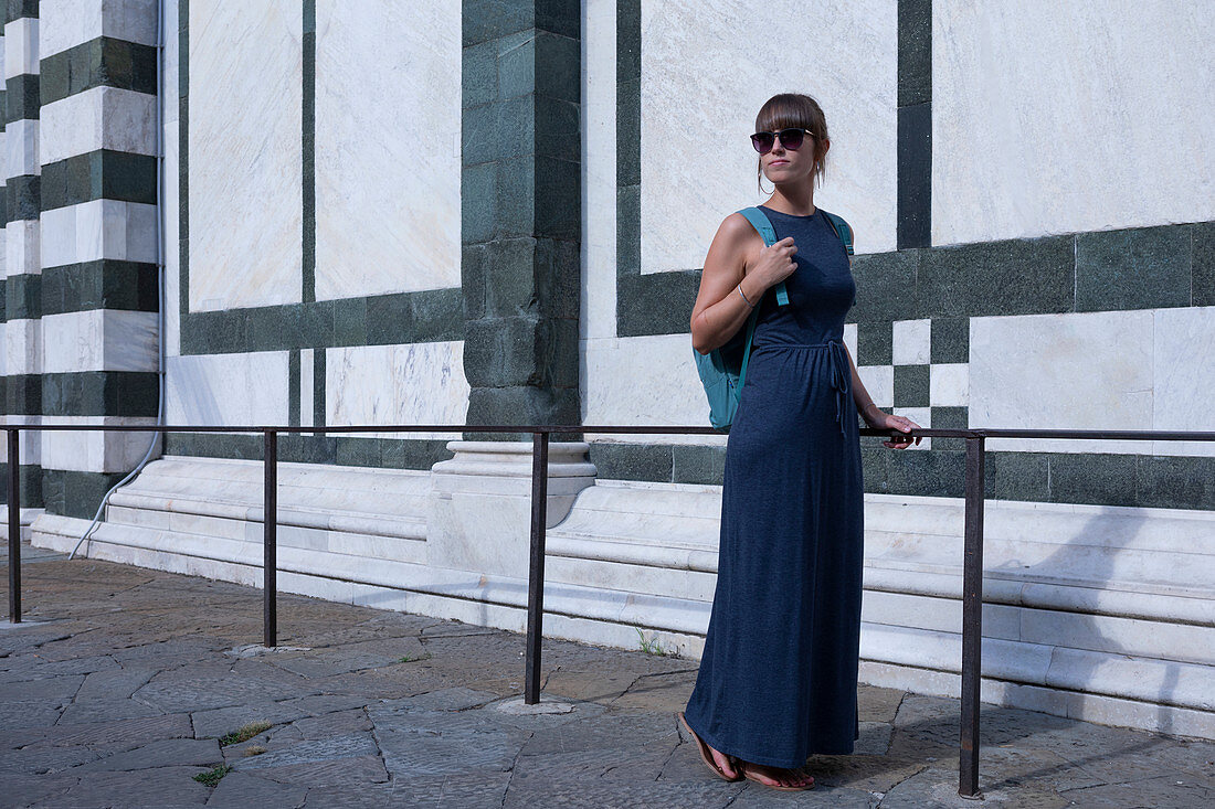 Woman in dress on facade of San Giovanni Baptistery in Florence, Tuscany Italy