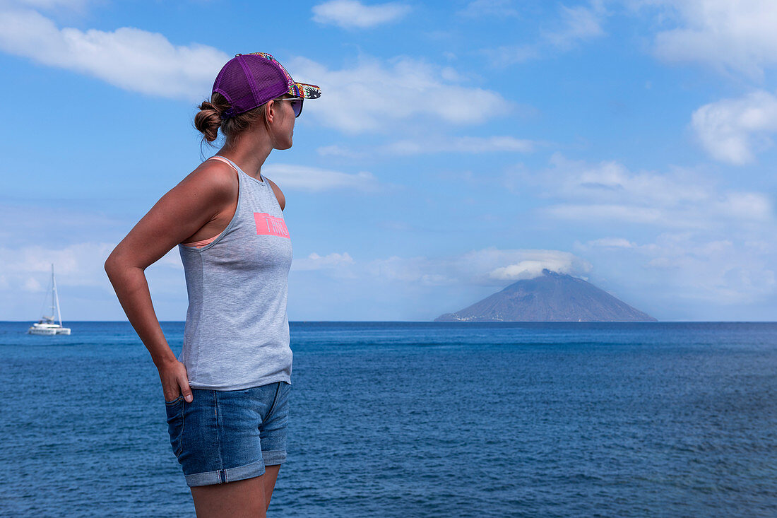 Woman on Panarea looking towards Stromboli, Sicily Italy