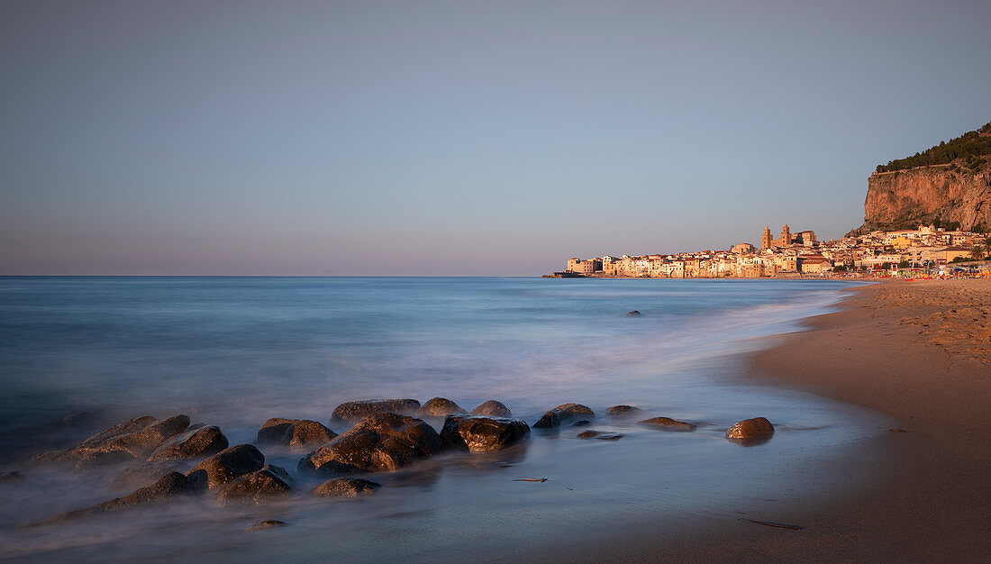 Cefalu city skyline with beach at sunset, Sicily Italy