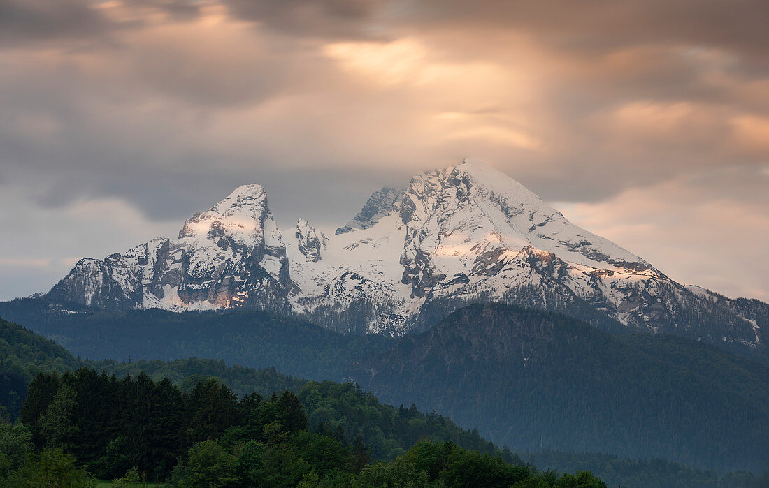 Snowy peaks of the Watzmann in Berchtesgaden with clouds at sunrise, Bavaria