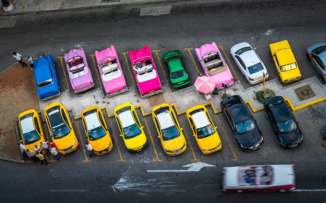 Aerial view of colourful old American taxi cars parked in Havana at dusk, La Habana, Cuba, West Indies, Caribbean, Central America