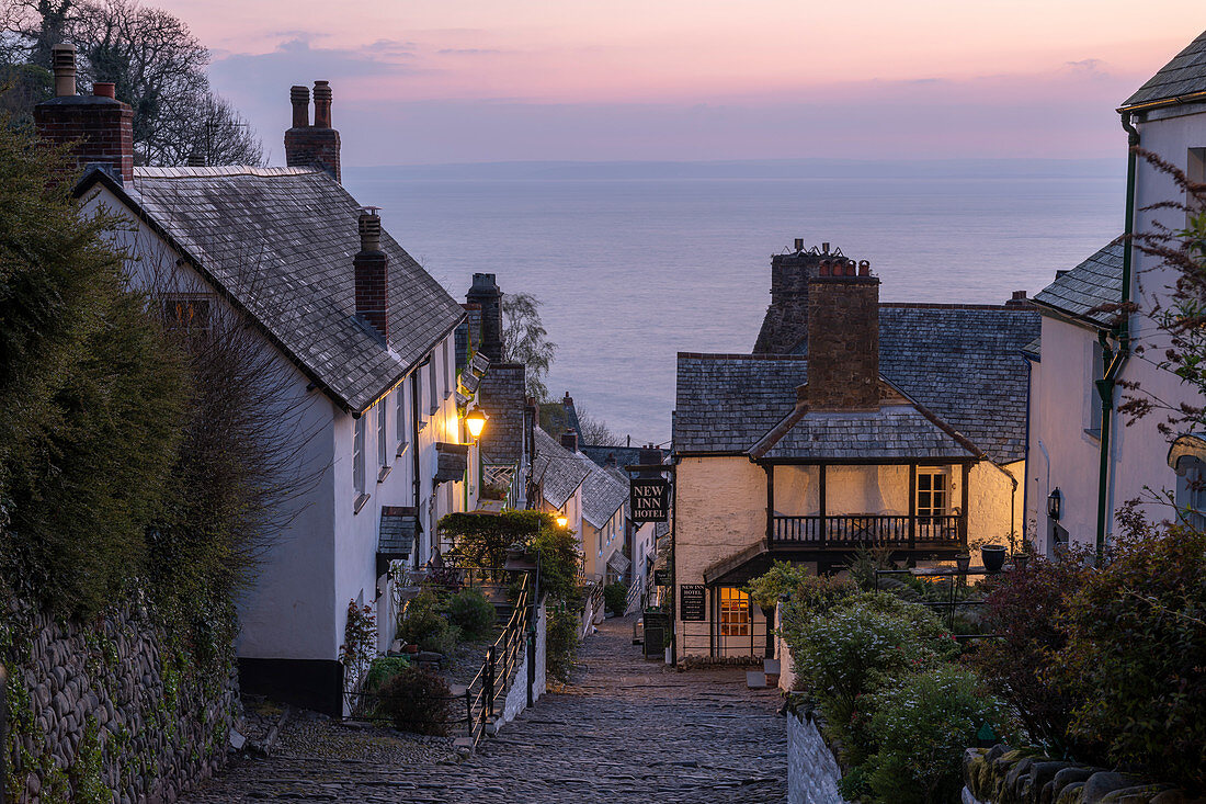 Pink dawn sky above the pretty village of Clovelly on the North Devon coast, Clovelly, England, United Kingdom, Europe