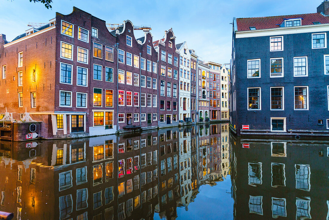Alte Giebelgebäude an einem Kanal in der Abenddämmerung, Oudezijds Kolk, Amsterdam, Nordholland, Niederlande, Europa