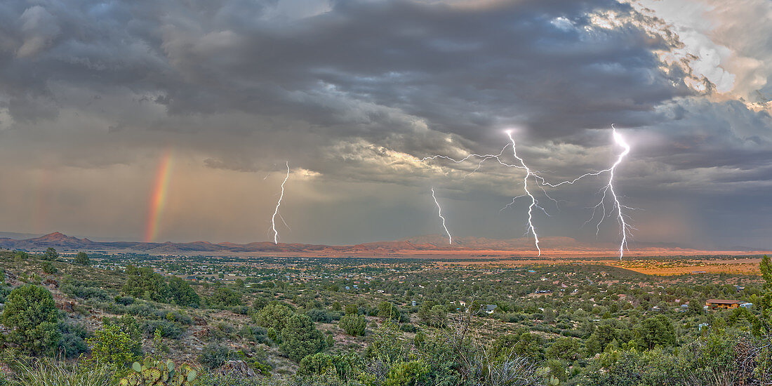 A lightning storm with a rainbow rolling over Mingus Mountain just east of Chino Valley, Arizona, United States of America, North America
