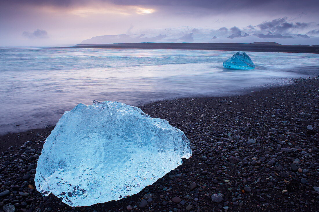 Iceberg washed ashore on Breidamerkursandur black sands, near Jokulsarlon glacial lagoon, East Iceland, Polar Regions