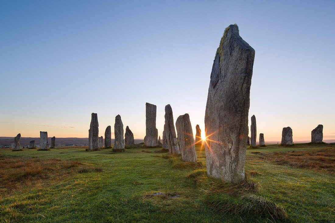 The sun rises at Callanish stone circle, Isle of Lewis, Outer Hebrides, Scotland, United Kingdom, Europe