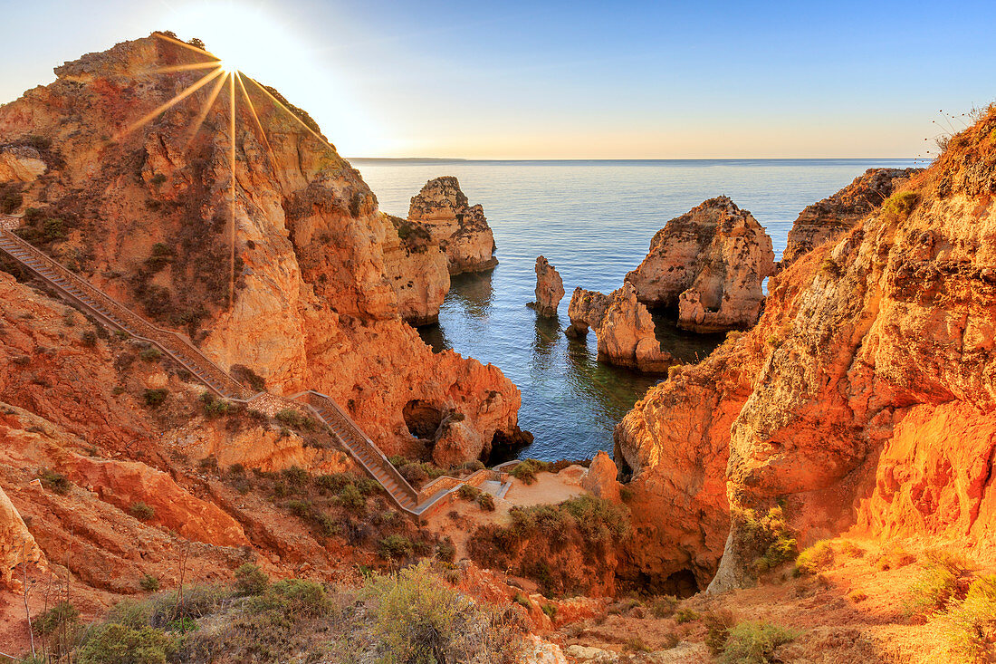 Goldener Sonnenaufgang über den roten Klippen von Ponta Da Piedade, Lagos, Algarve, Portugal, Europa