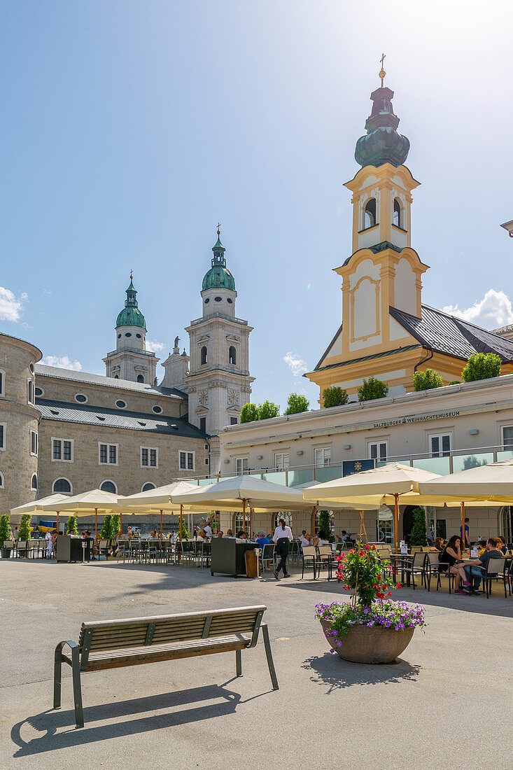 View of St. Michaelskirche and Salzburg Cathedral in Residenzplatz, Salzburg, Austria, Europe