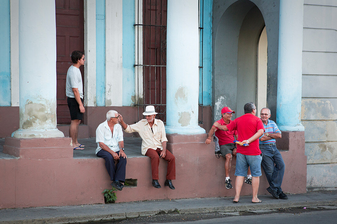 Men talking on the street of Cienfuegos, Cuba