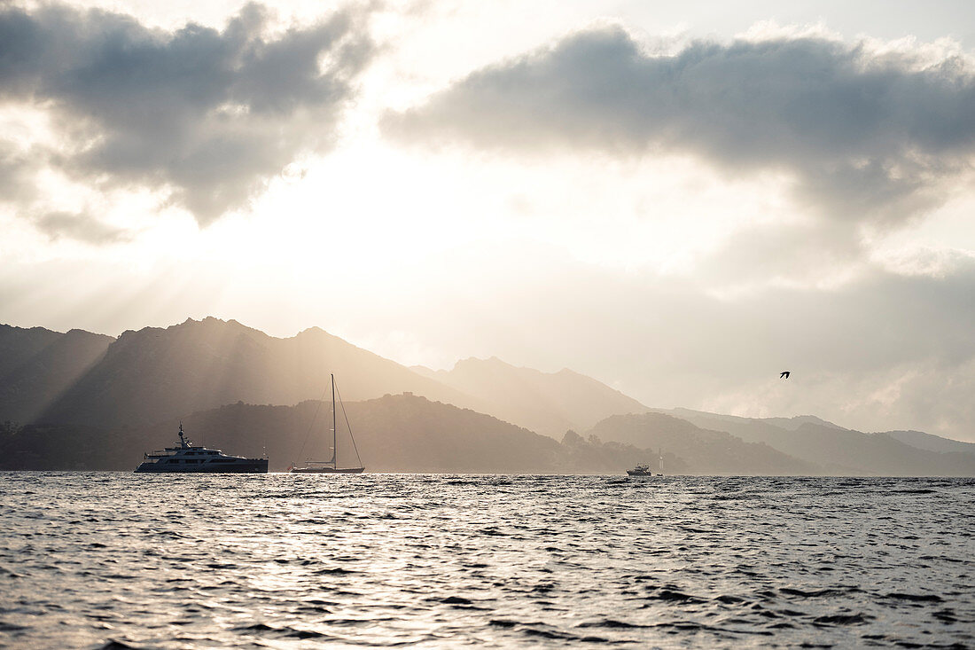 Boats and yachts in the evening light in front of Saint Florent, Corsica, France.