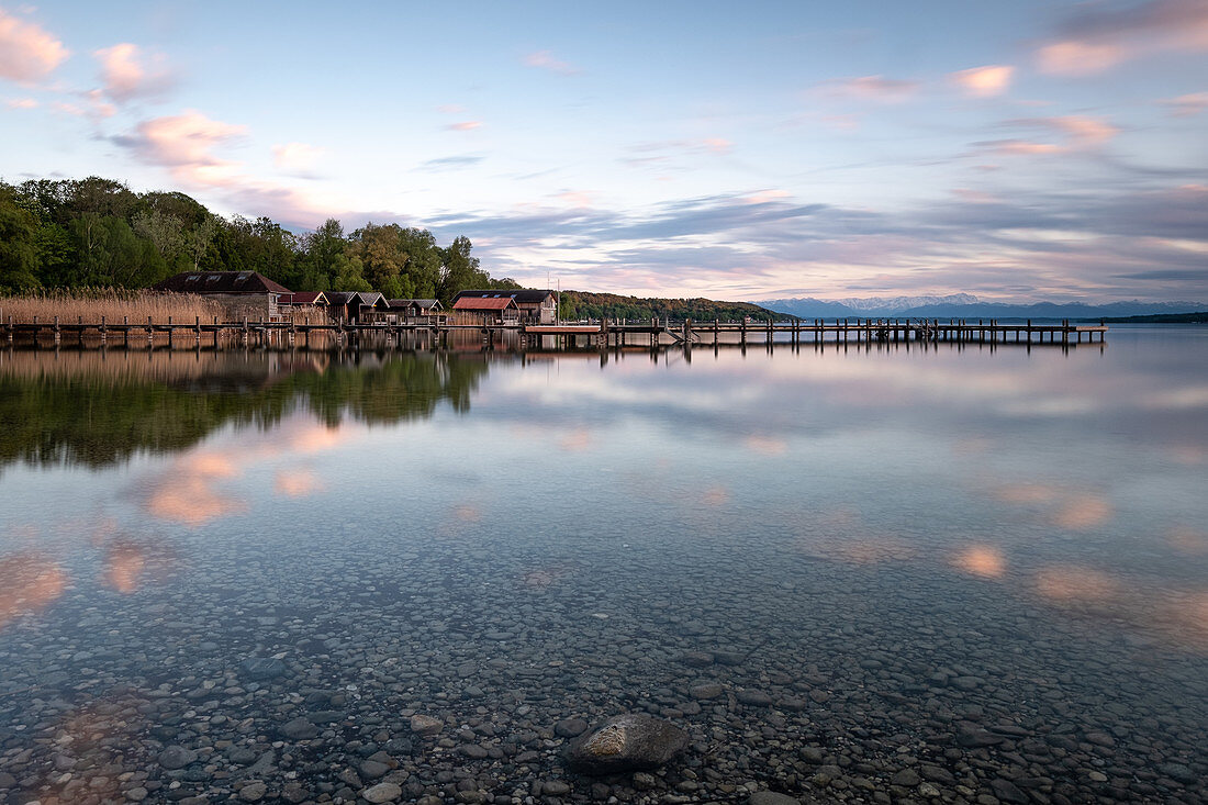 View of a deserted jetty on Lake Starnberg at sunset, in the background the Alps, Starnberg; Bavaria; Germany; Europe