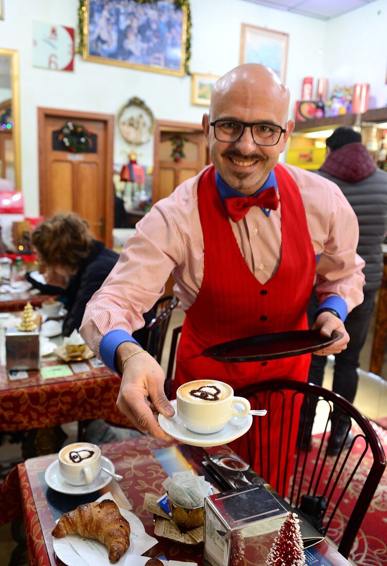 Ober serves two cappuchino, cafe in Sicily, Italy