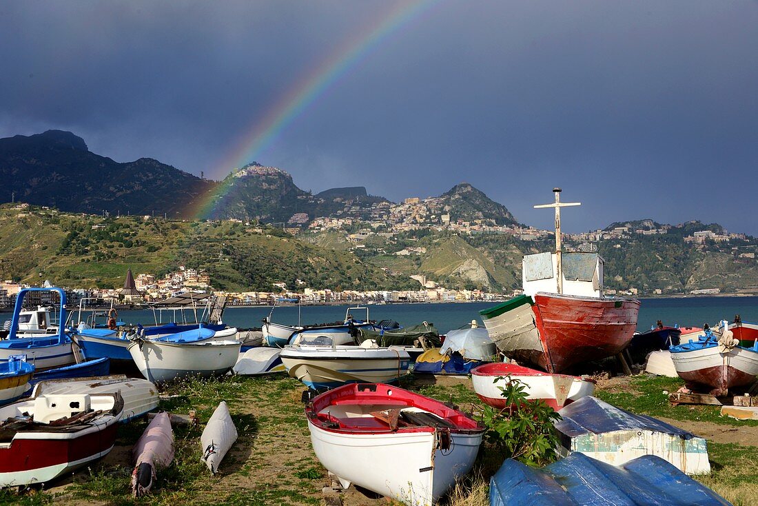 Boats and rainbows on the beach at Giardini Naxos below Taormina, east coast, Sicily, Italy