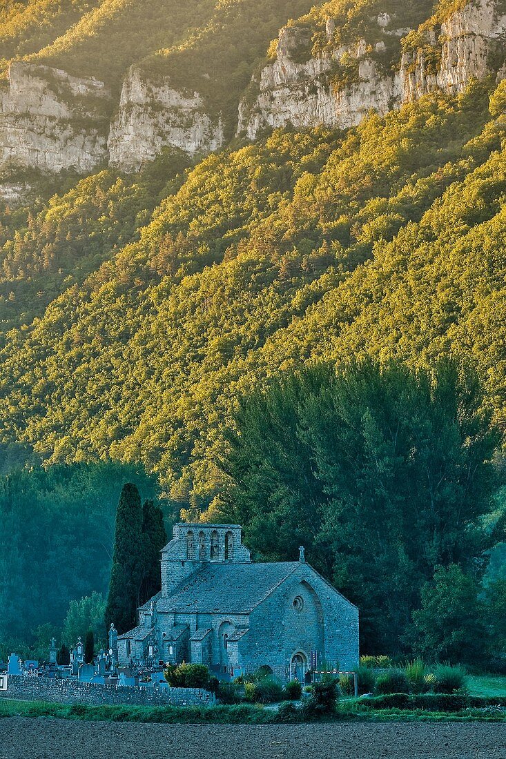 France, Aveyron, Parc Naturel Regional des Grands Causses (Natural regional park of Grands Causses), Church at the foot of the mountain
