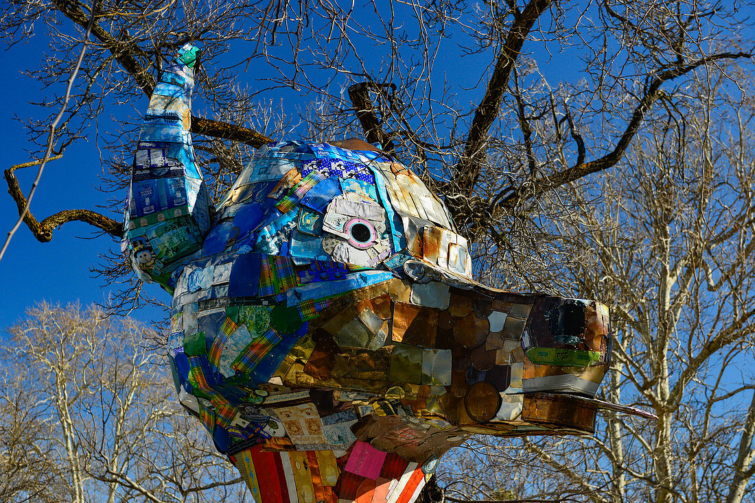 A sculpture of an animal head, made from metal parts, in the city of Davis, California, USA