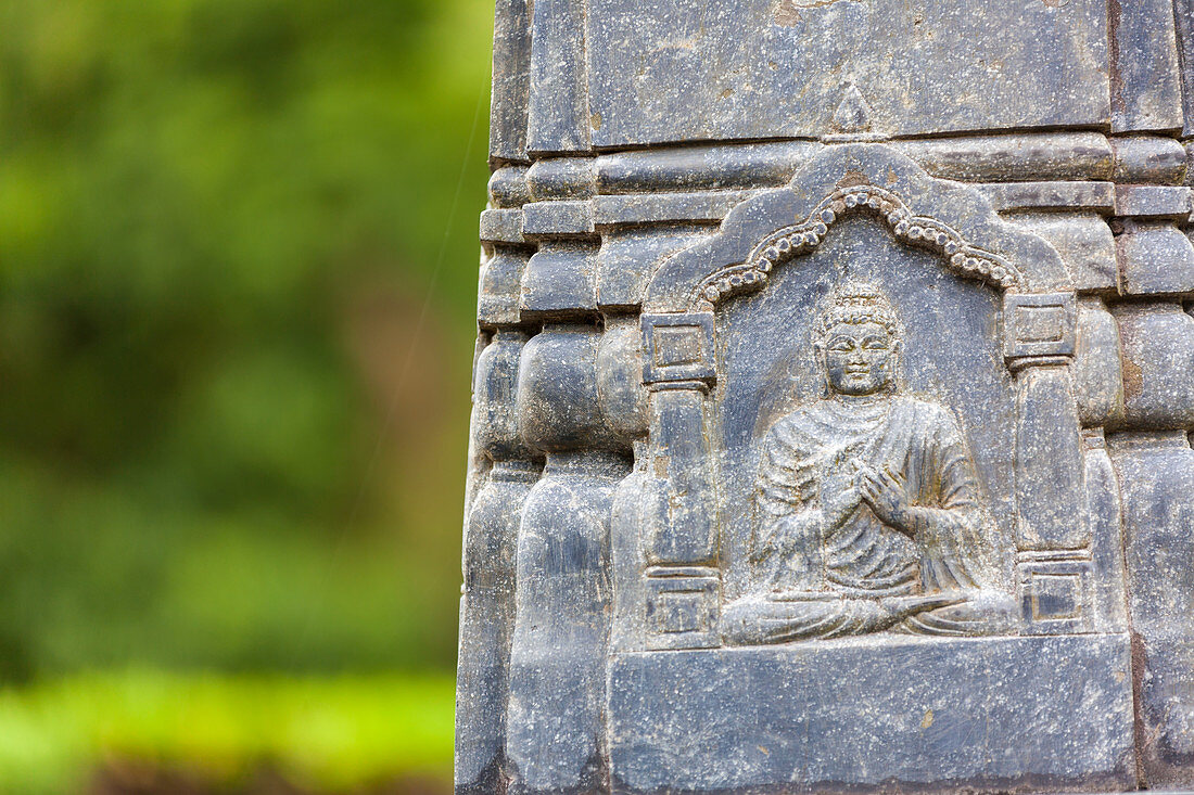 Close up of a carving of Buddha on a statue at an Buddhist Temple, Okayama, Japan.