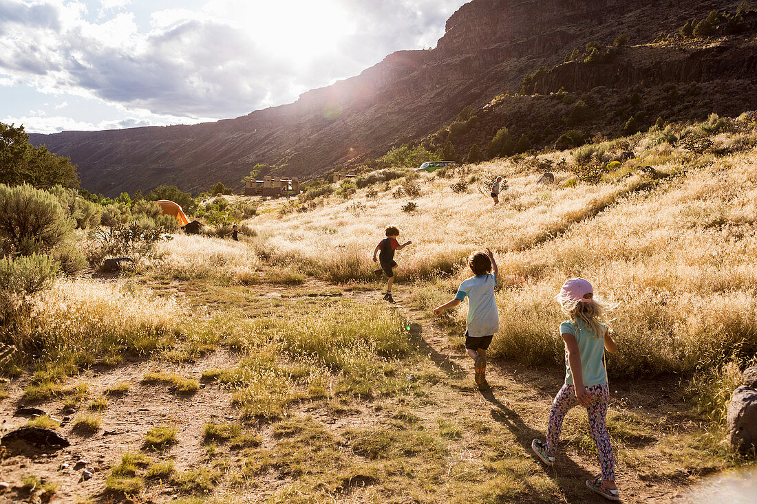 children hiking at sunset,Pilar, NM.