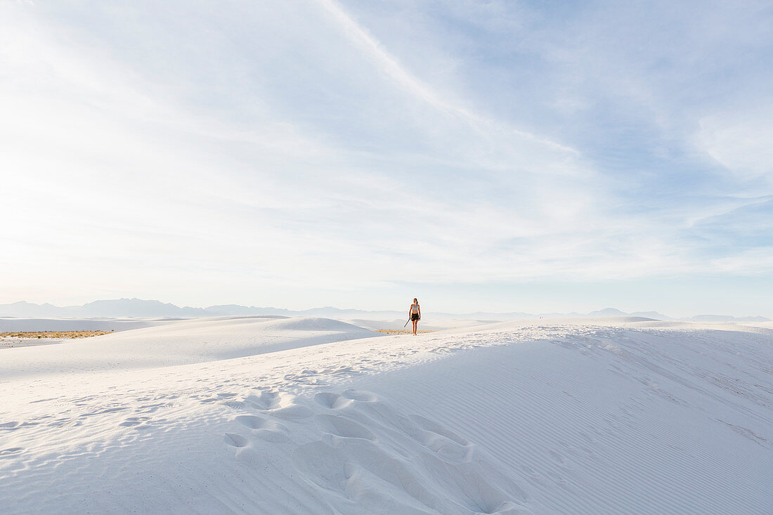 woman walking in the dunes, White Sands Nat'l Monument, NM