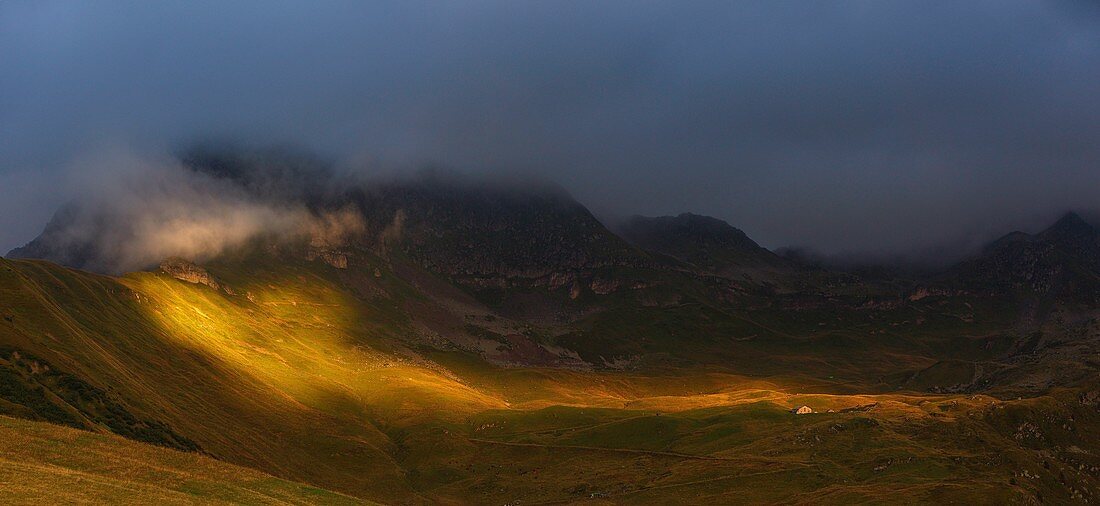 France, Savoie, Beaufortain, Hauteluce, view peaks and alpine meadows at sunset, under a cloudy sky