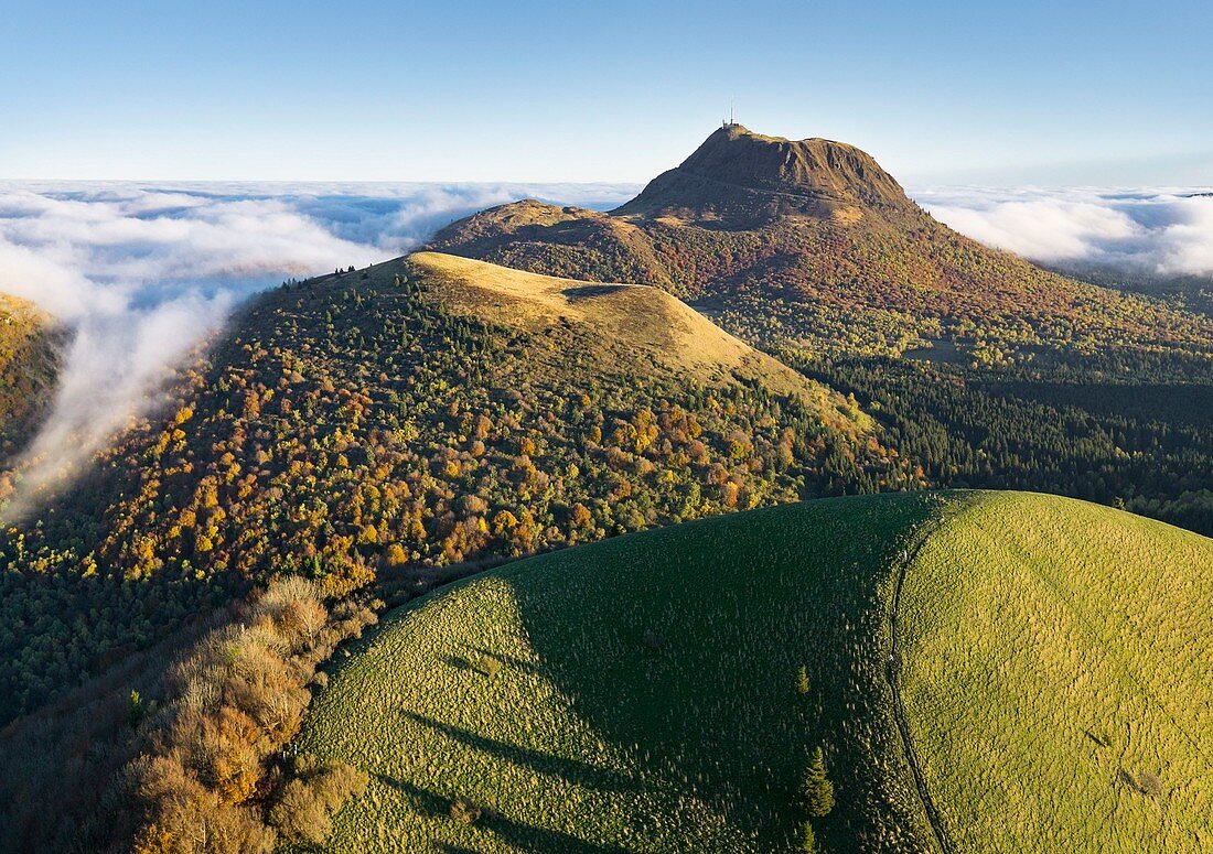 France, Puy de Dome, area listed as World Heritage by UNESCO, Ceyssat, Chaine des Puys, Regional Natural Park of the Auvergne Volcanoes, summit of Puy de Come volcano and Puy de Dome in the background (aerial view)